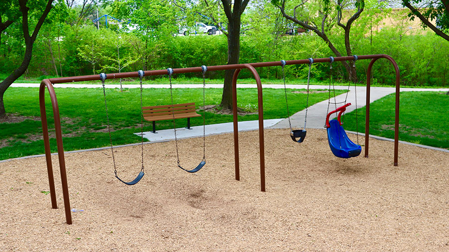Swings and bench at Ad Astra Park playground
