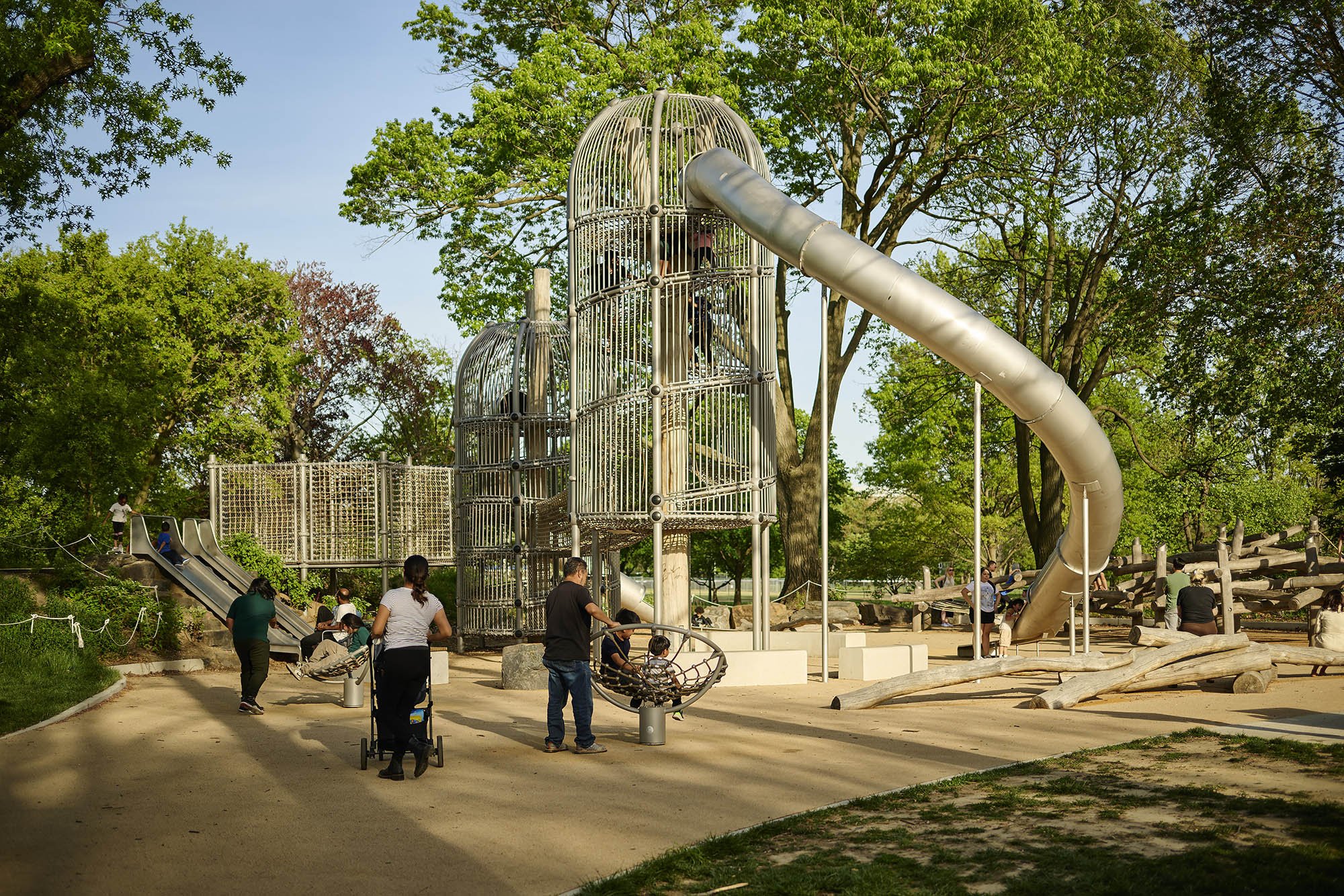 Families using the inclusive play space at Anna C. Verna Playground