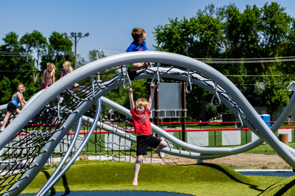 Children playing on the inclusive playground at Aspen Seemann Memorial Park