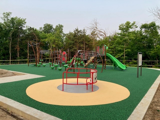 Main Binder Park playground structure with slides and inclusive surfacing