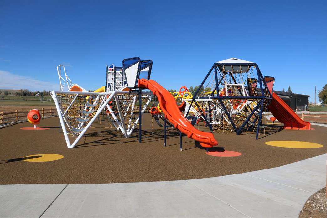Ribbon cutting and playground structures at Black Tooth Park in Sheridan