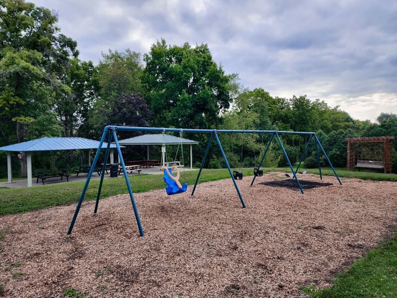 Wide view of the children's playground and pavilion at the Dubuque Arboretum