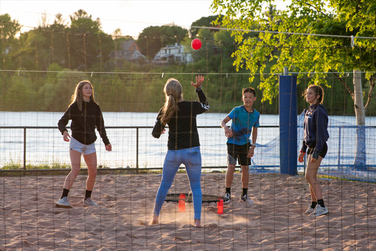 People using the volleyball and recreation area along Houghton's waterfront