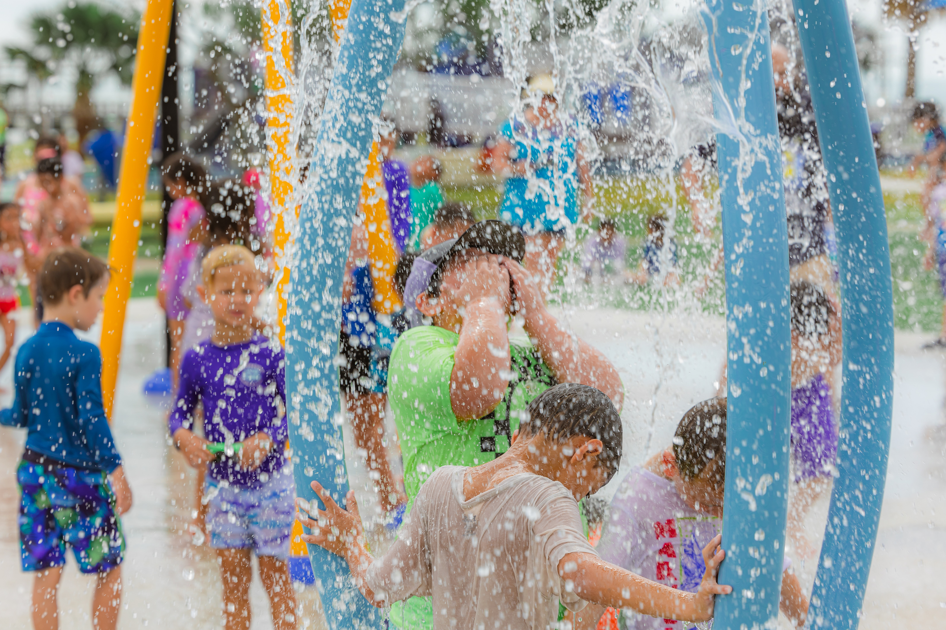 Kids using the splash pad at Cole Park