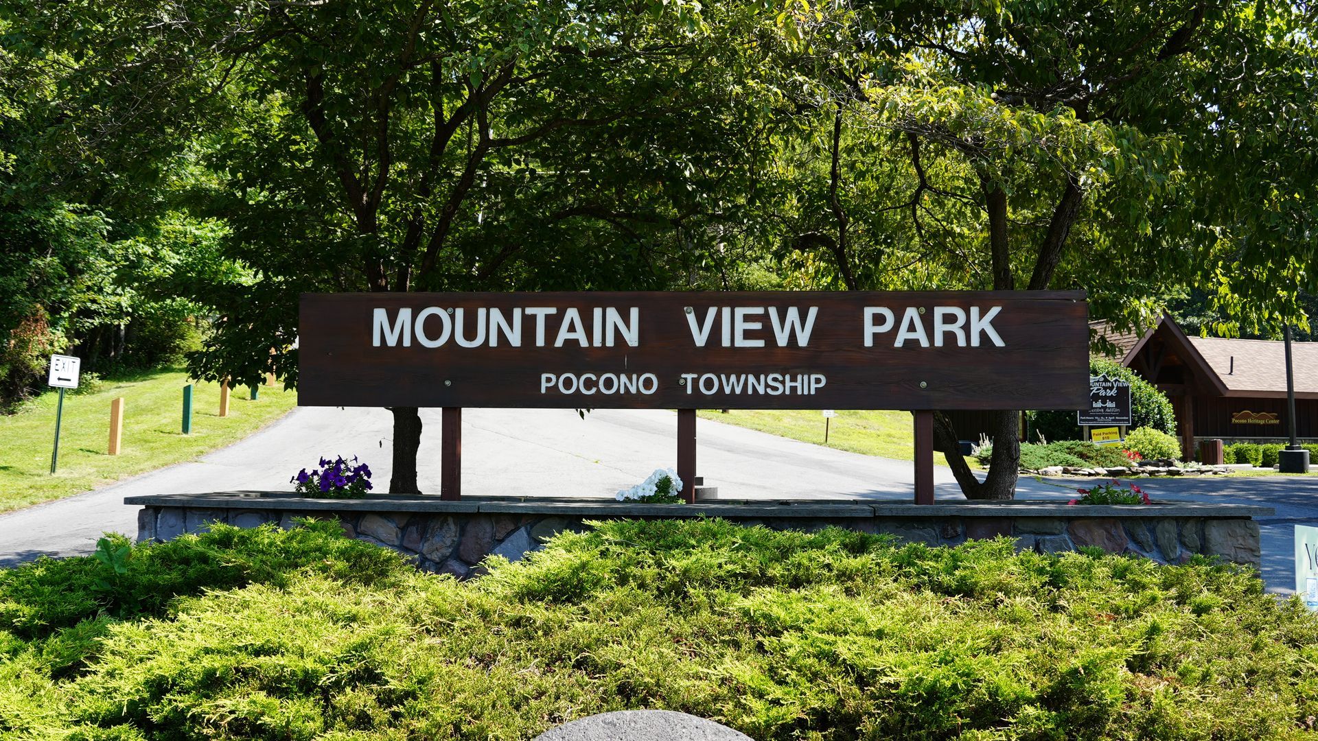 Entrance sign for Mountain View Park surrounded by trees