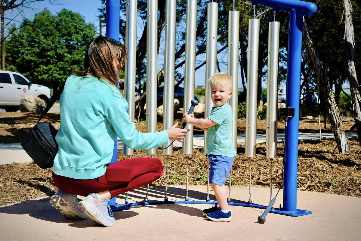 Child using oversized xylophone at Dan Markson Park