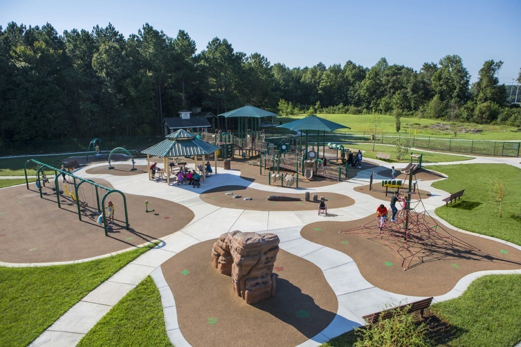 Inclusive playground with shade structures at Destination Park