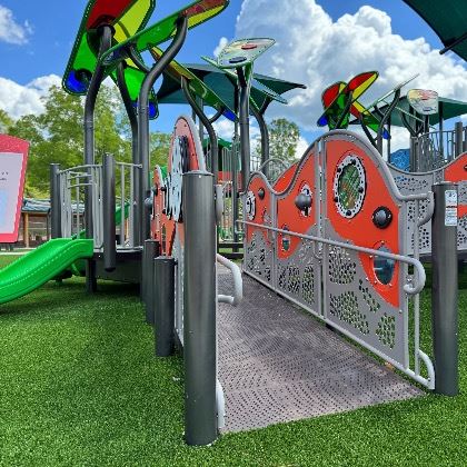 Wheelchair-accessible ramp leading into Floral Park Inclusive Playground