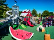 Funland playground with watermelon and barn-themed structures