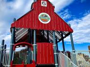 Barn-themed play structure at Funland Playground