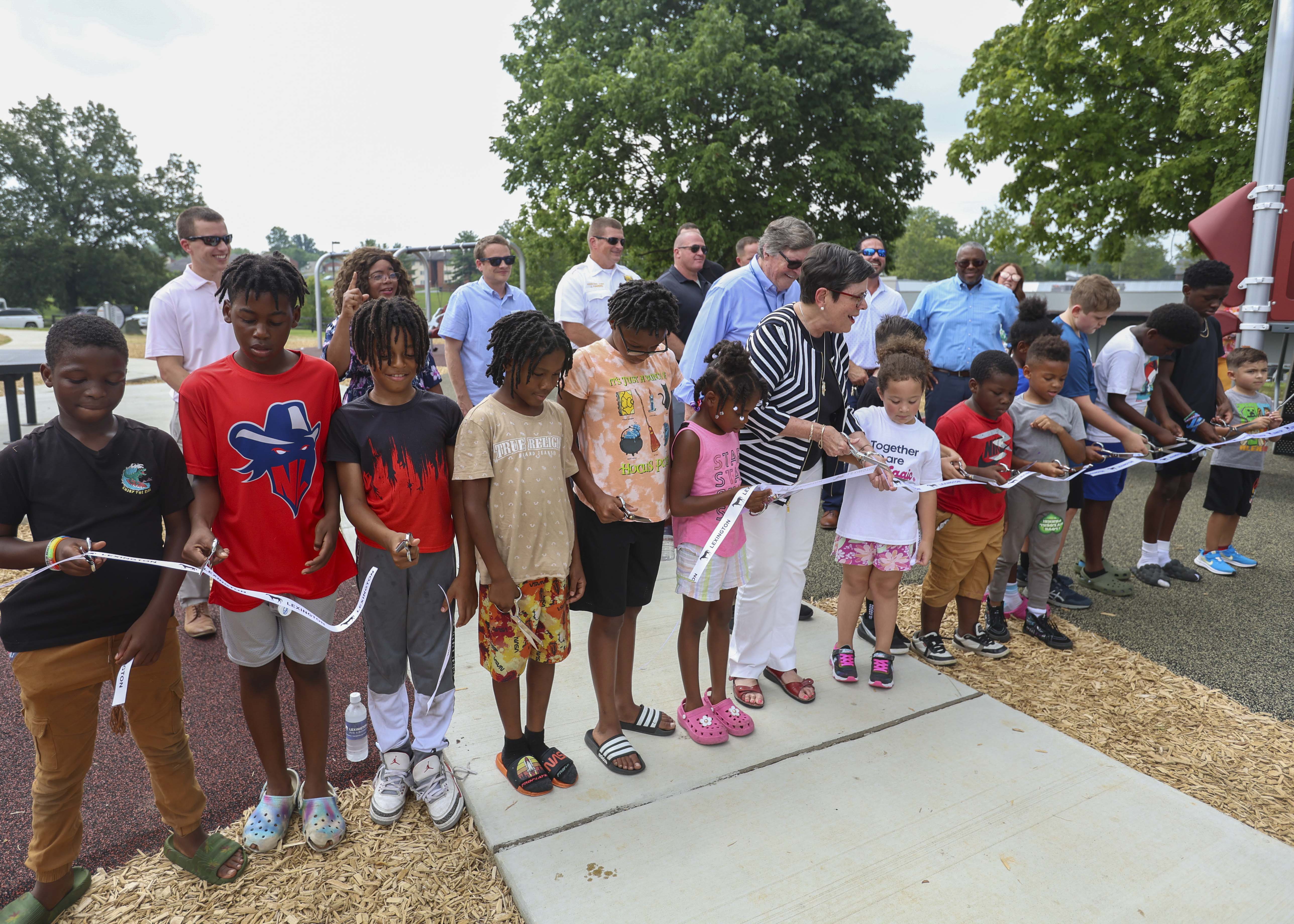 Children gathered with officials at the new Gainesway Park playground