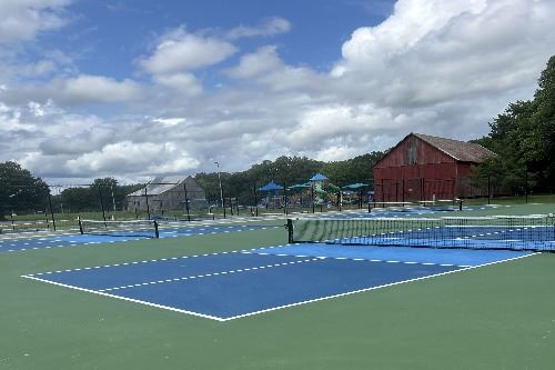 Park setting at Hallowing Point Park with courts and playground in the background.