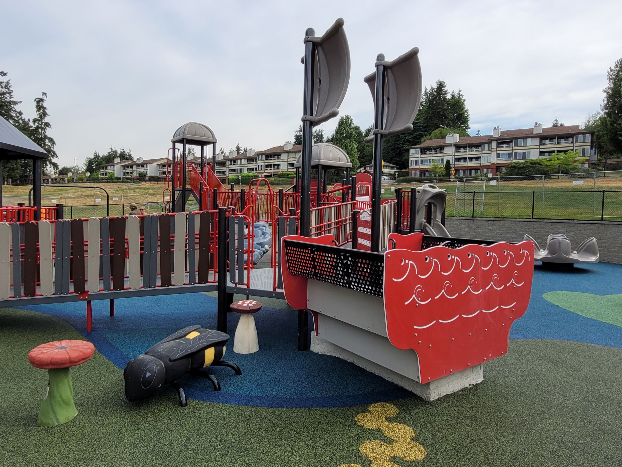 Boat-themed and bee-themed playground features at Hazel Miller Universally Accessible Playground