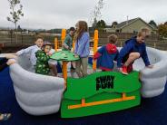 Children playing on the inclusive and accessible play structure at Jay Pearson Neighborhood Park