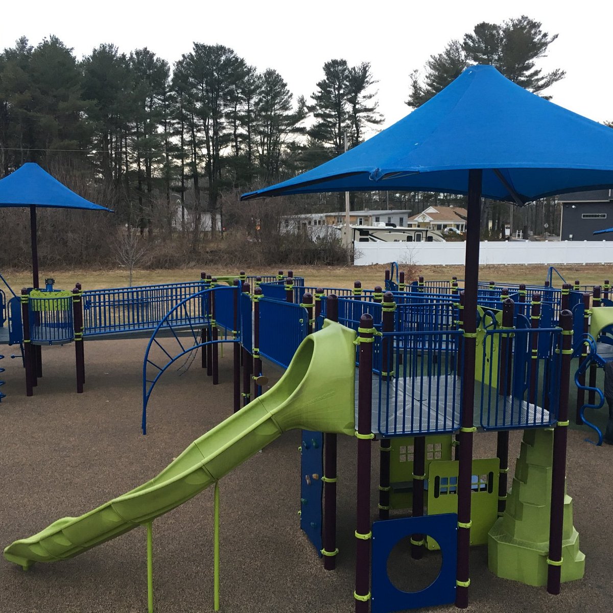 Main play structure with umbrellas and slides at Jessica's Boundless Playground