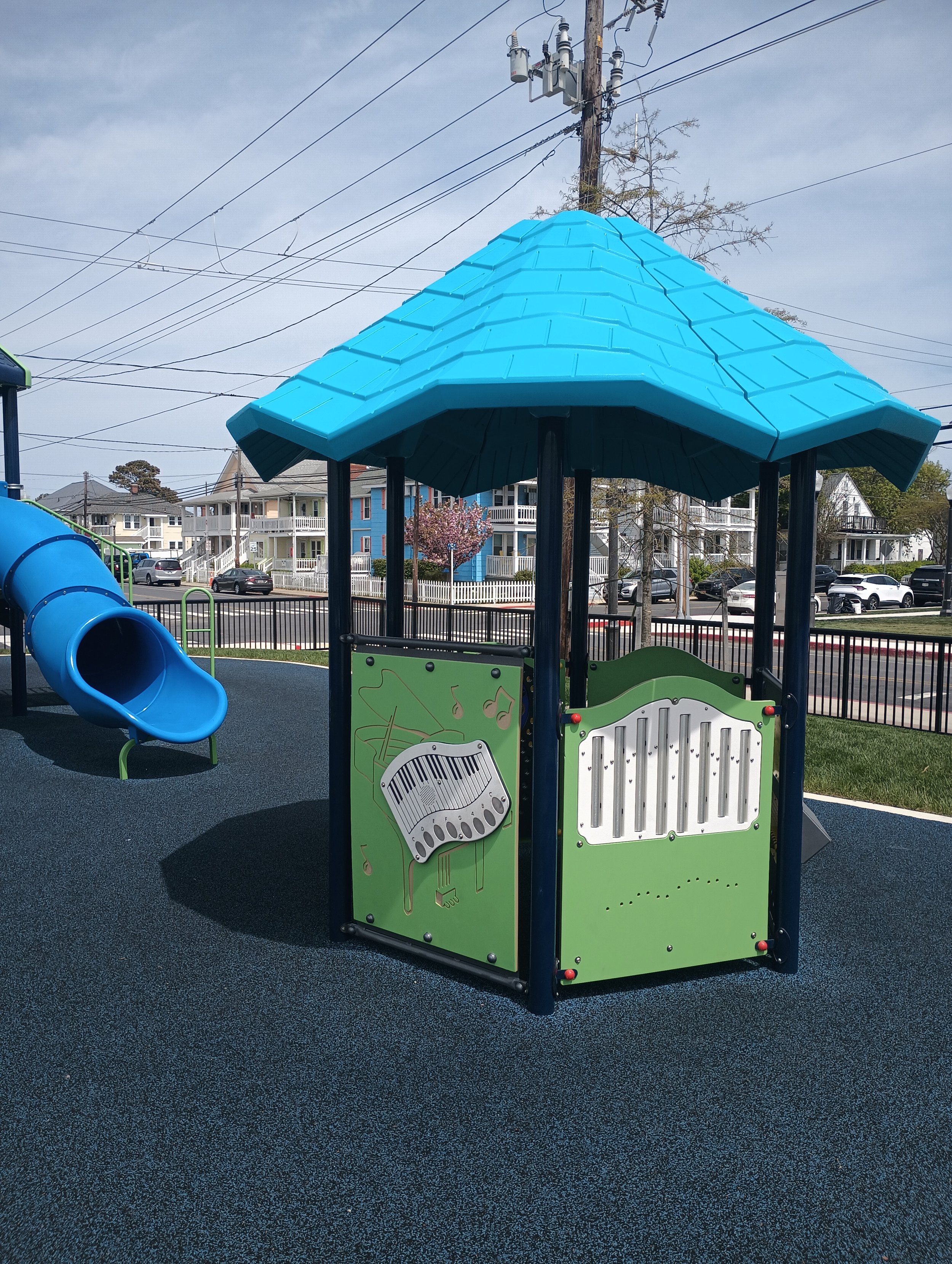 Small inclusive playground with rubberized surfacing.