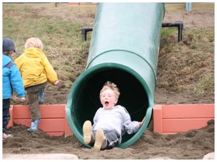 Play equipment and hillside setting at Karen Hornaday Park Playground