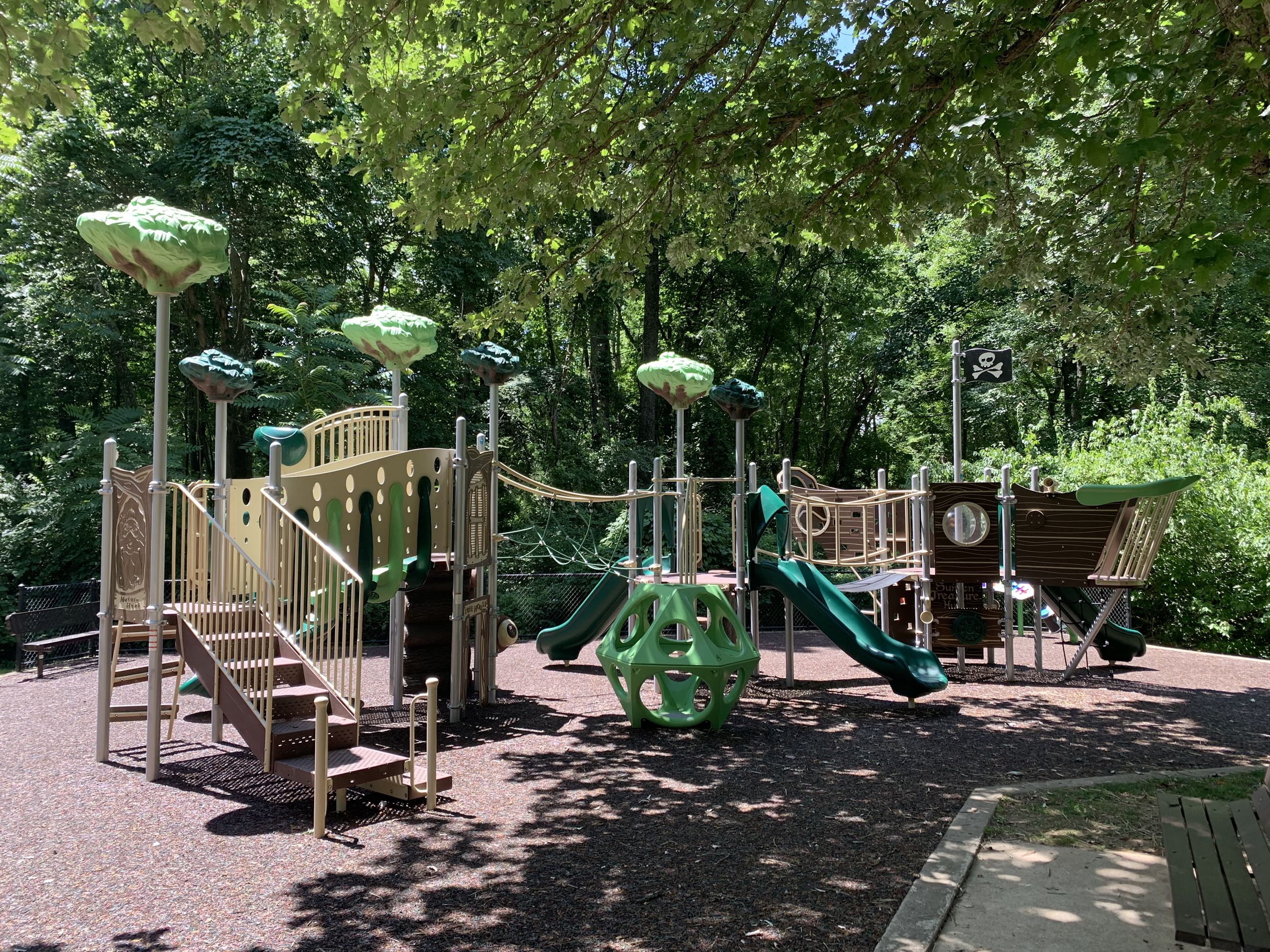 Forest-themed playground with slides and ramps at Kemptown Park