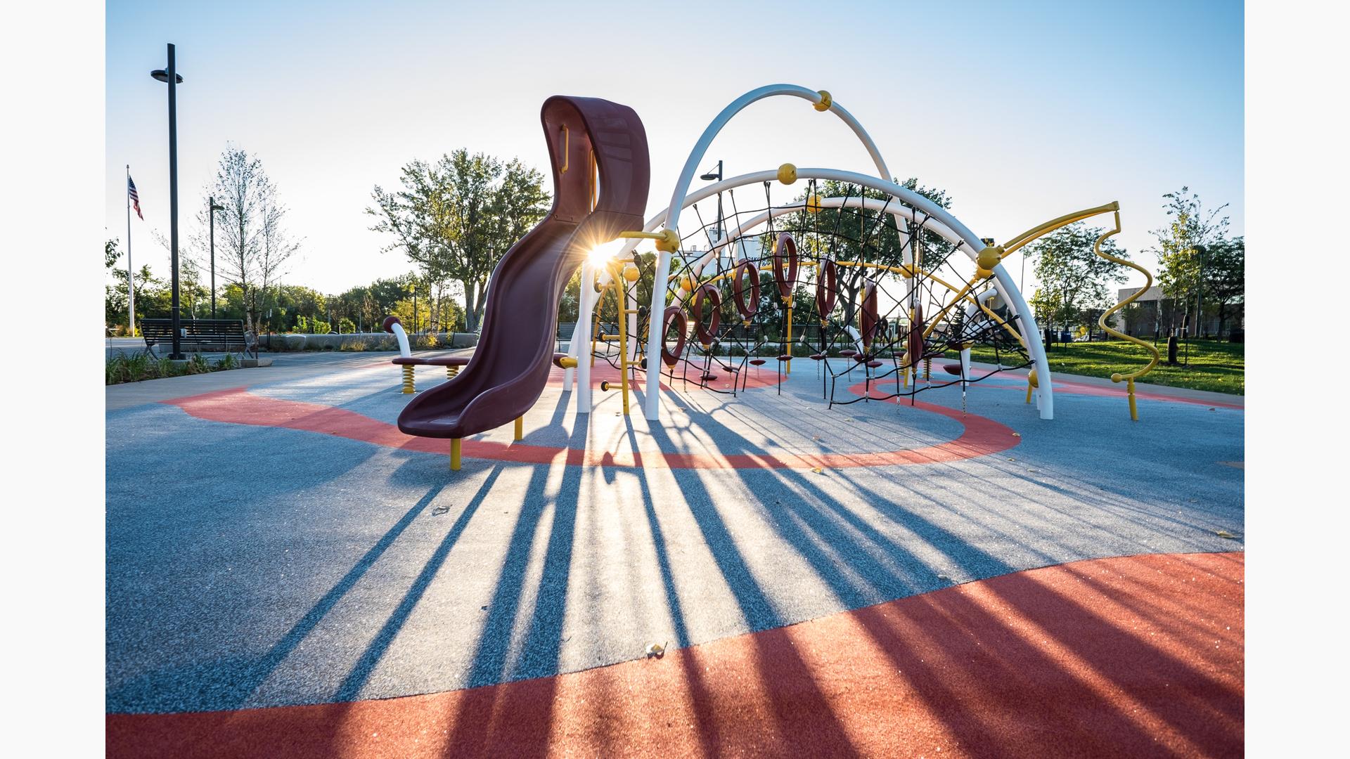Children using climbing and motion features at Legacy Commons