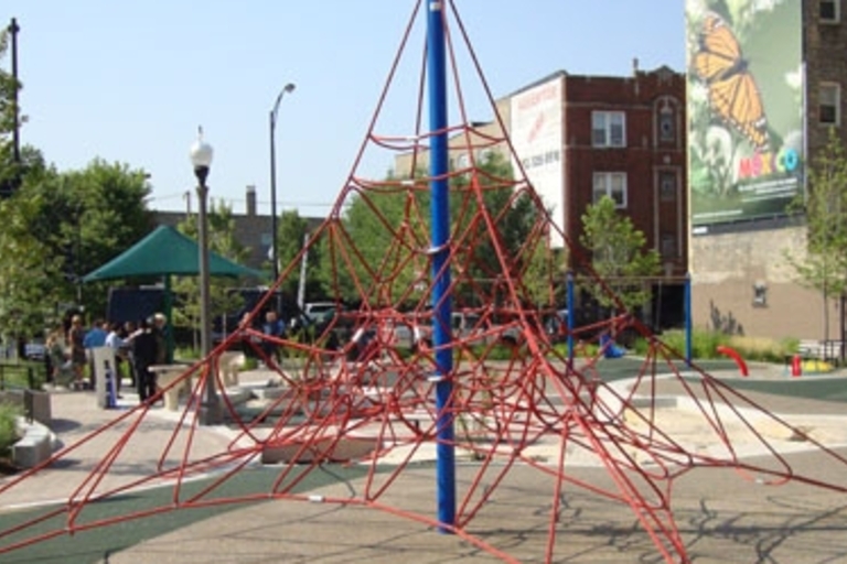 Red climbing dome at Lucy Parsons Park playground.
