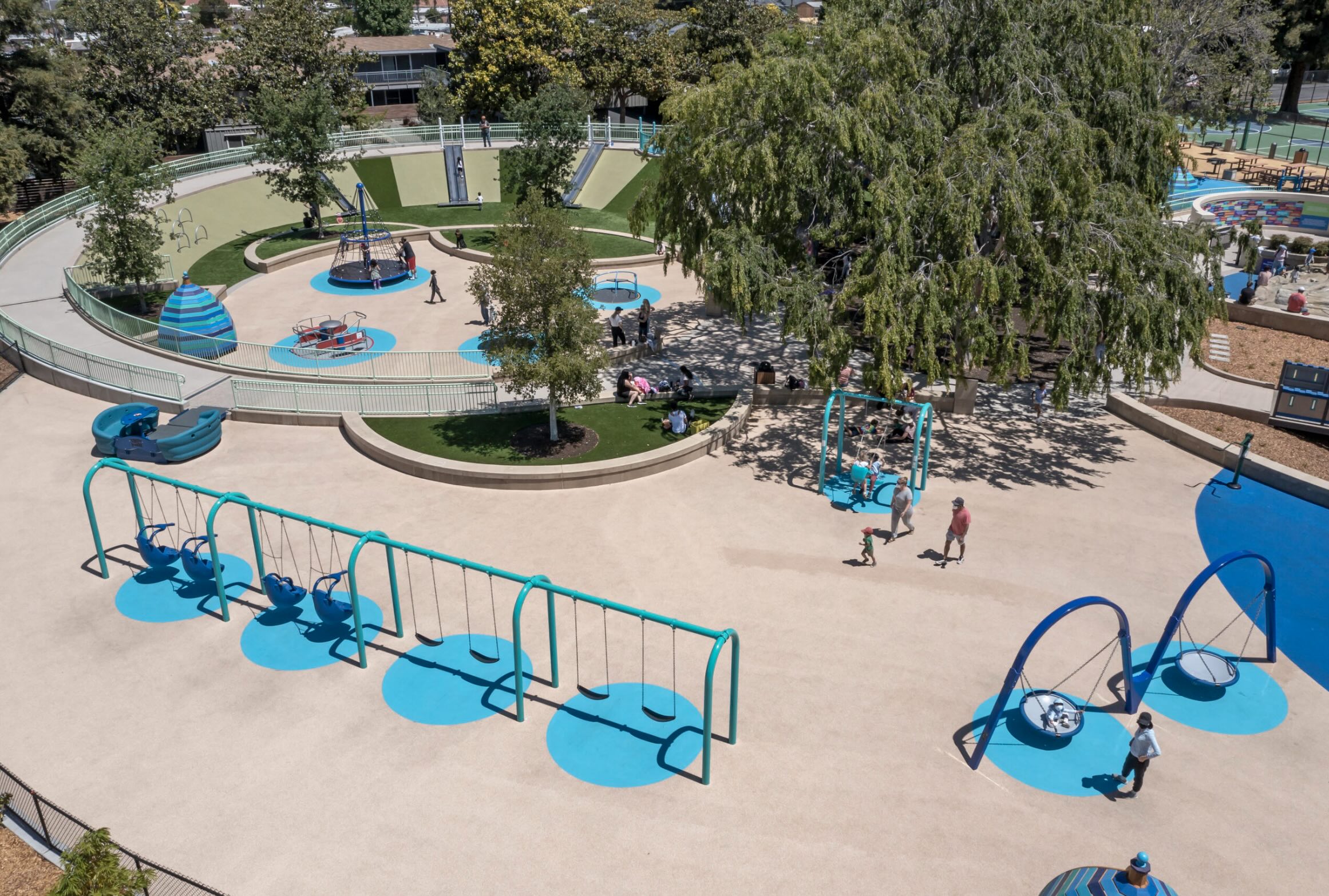 Slide, spin, and swing area at Magical Bridge Playground in Sunnyvale