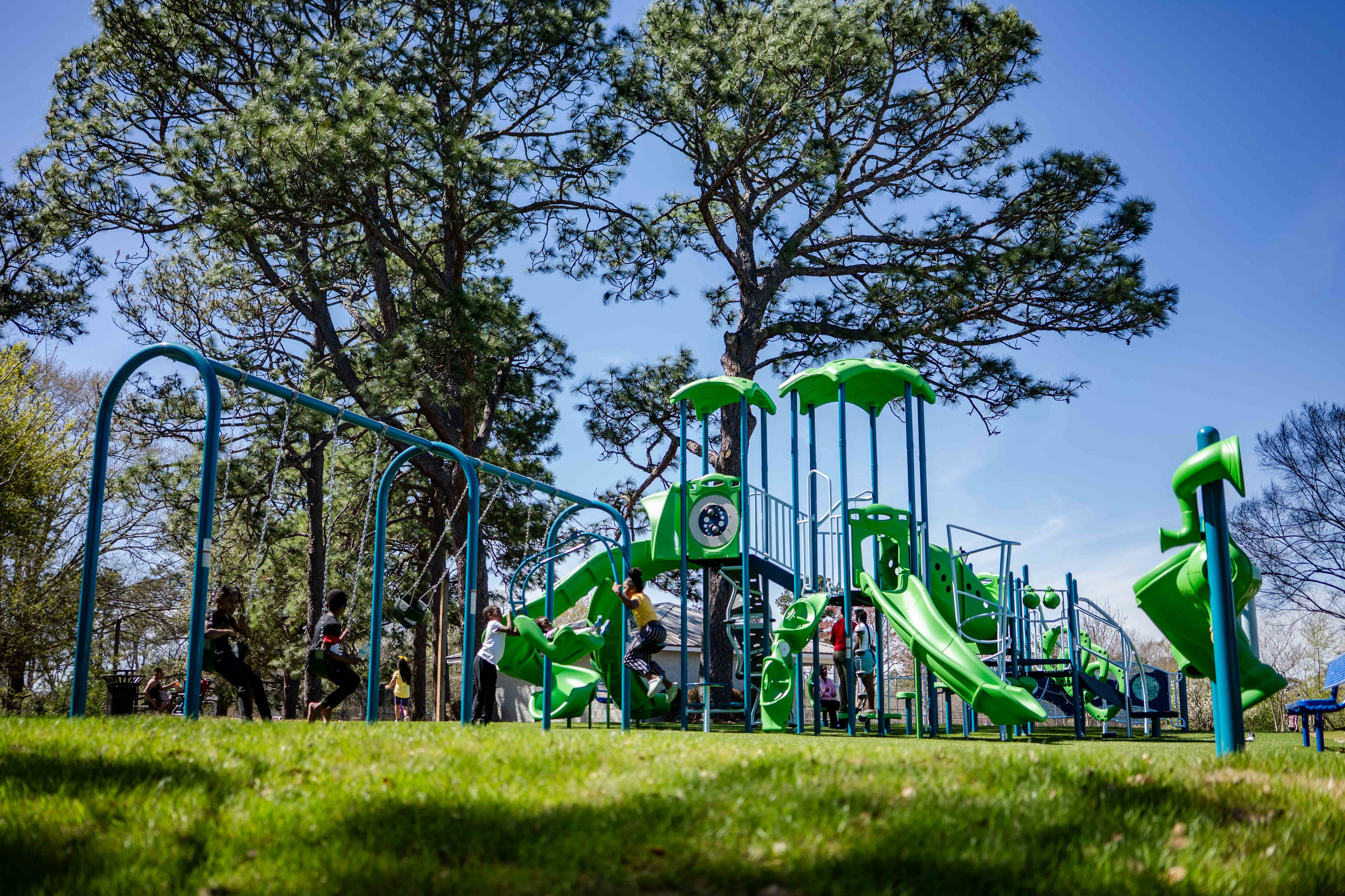 Ground-level view of playground features at Midtown Green