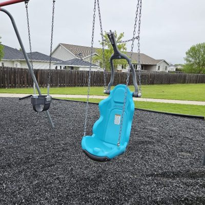 Ground-level and interactive play features at the Minot Family YMCA playground