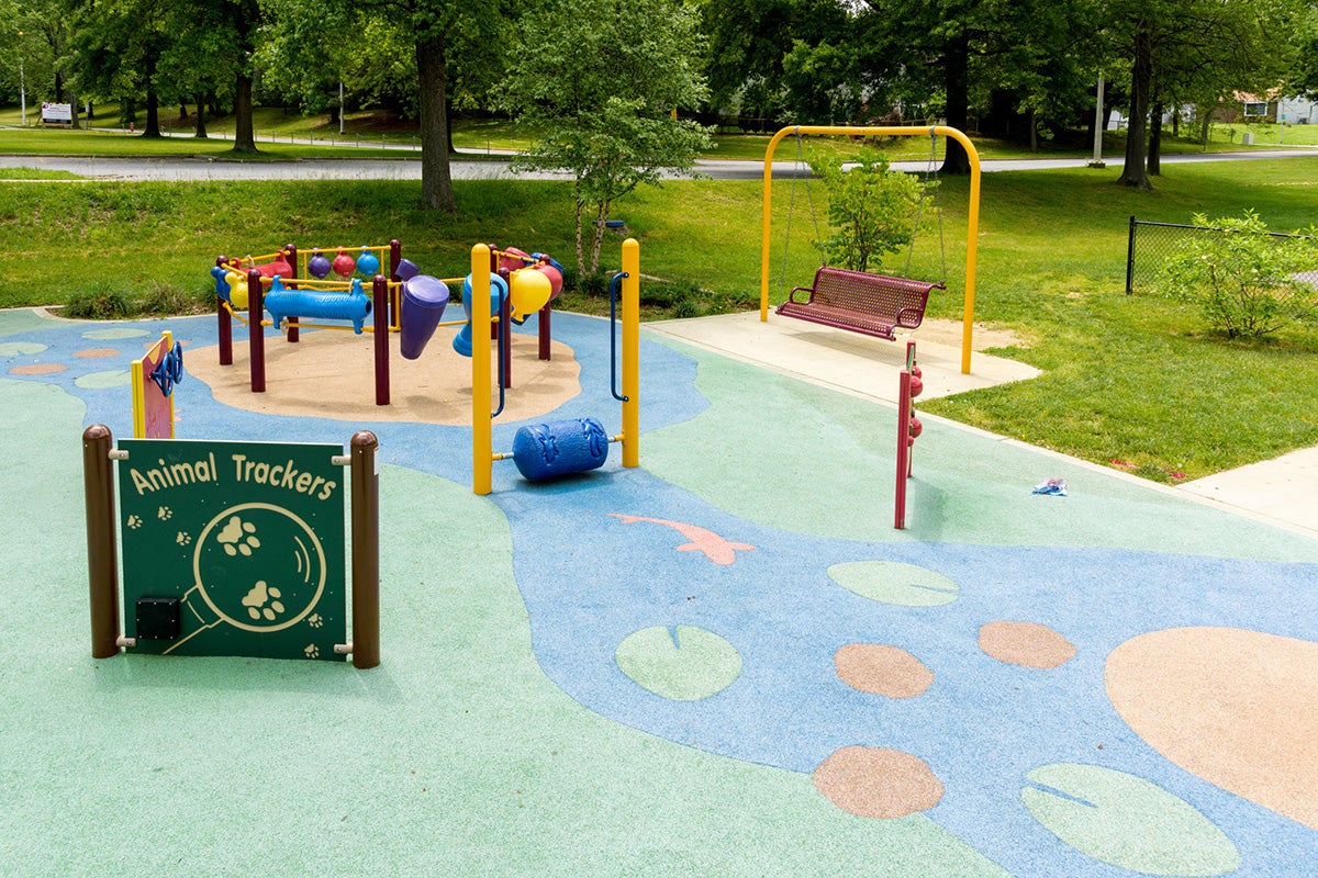 Interactive ground-level play area with stream-themed surfacing at Mitchellville South Park