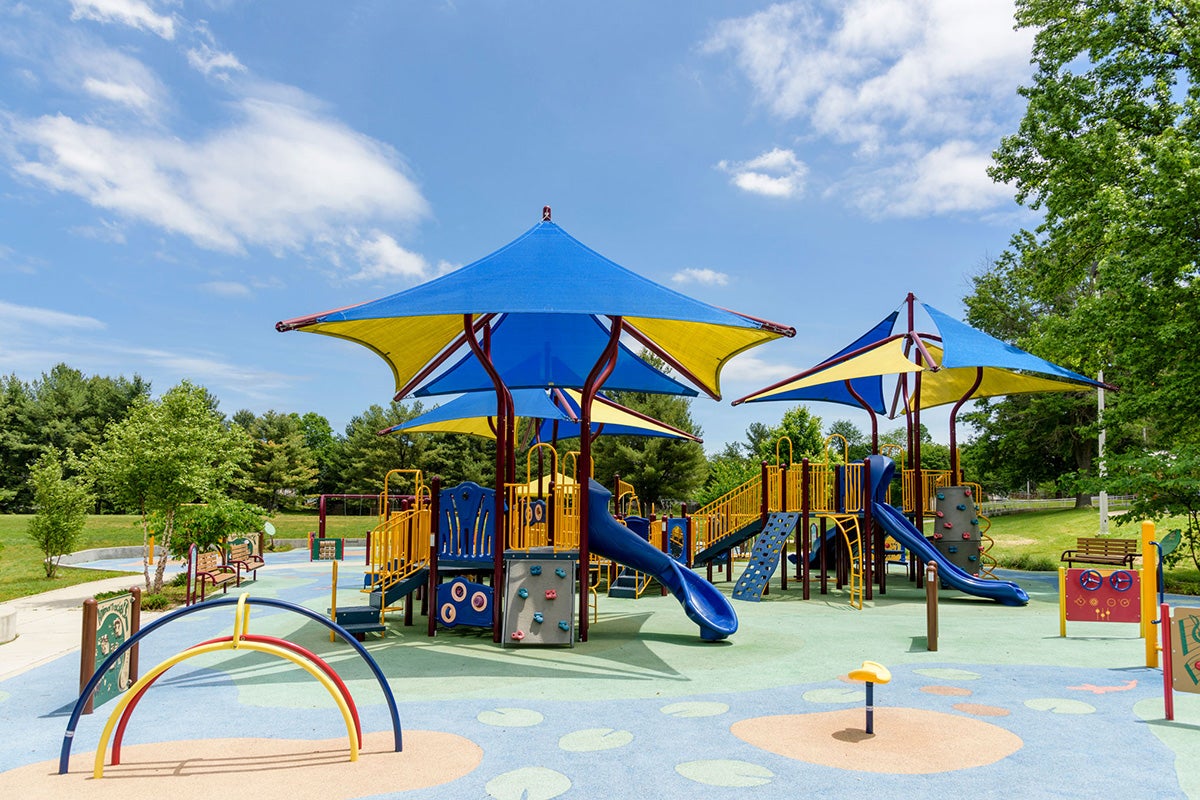 Wide view of the colorful playground at Mitchellville South Park in Bowie
