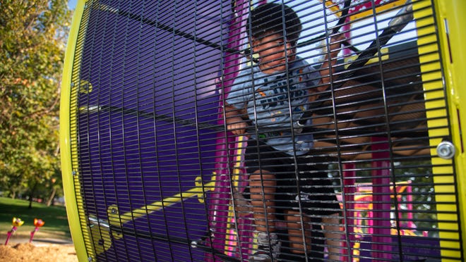 Inclusive playground at Otto Sandman Park with bright multi-color play structures