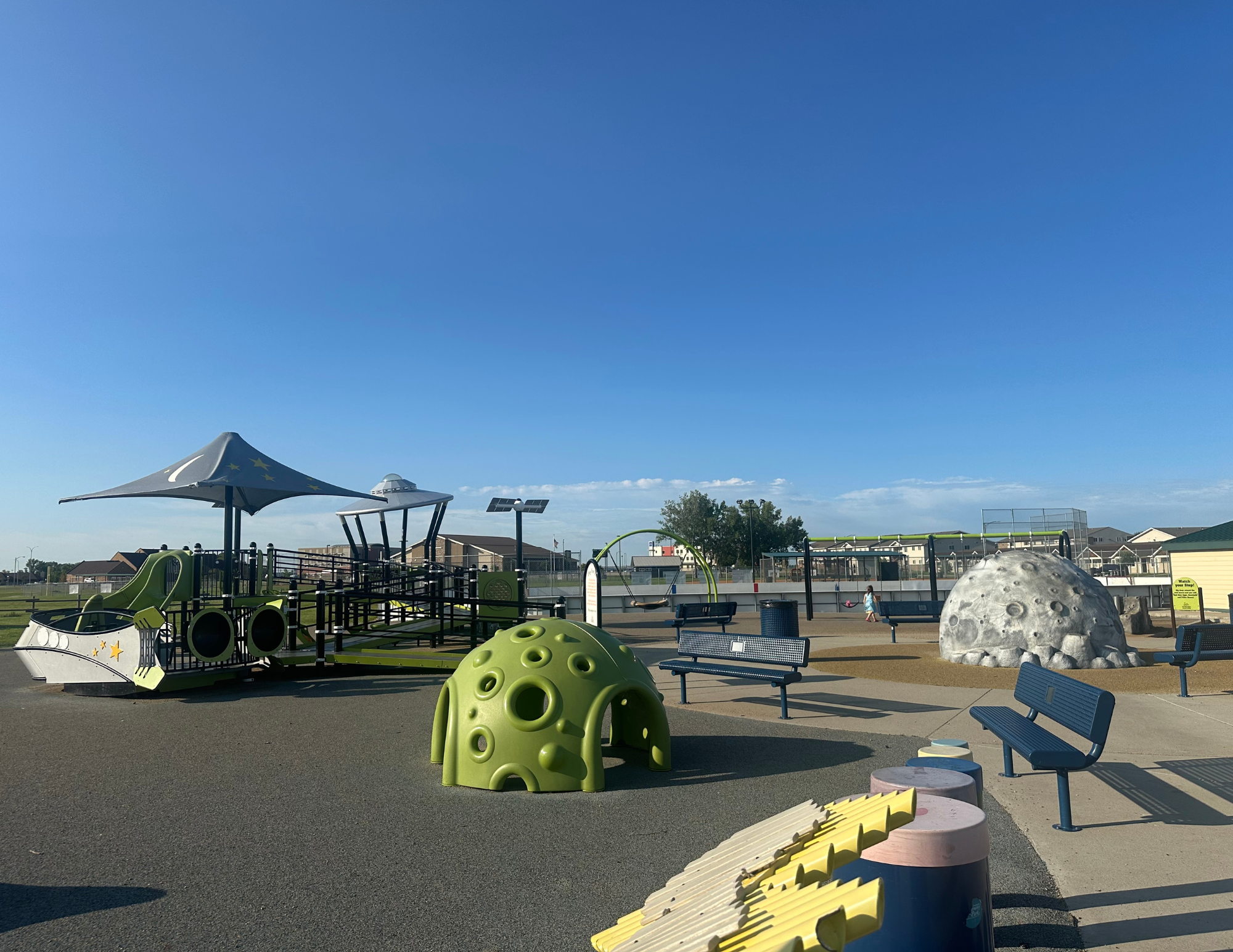 Space-themed play equipment and seating at Play 4 All in Williston