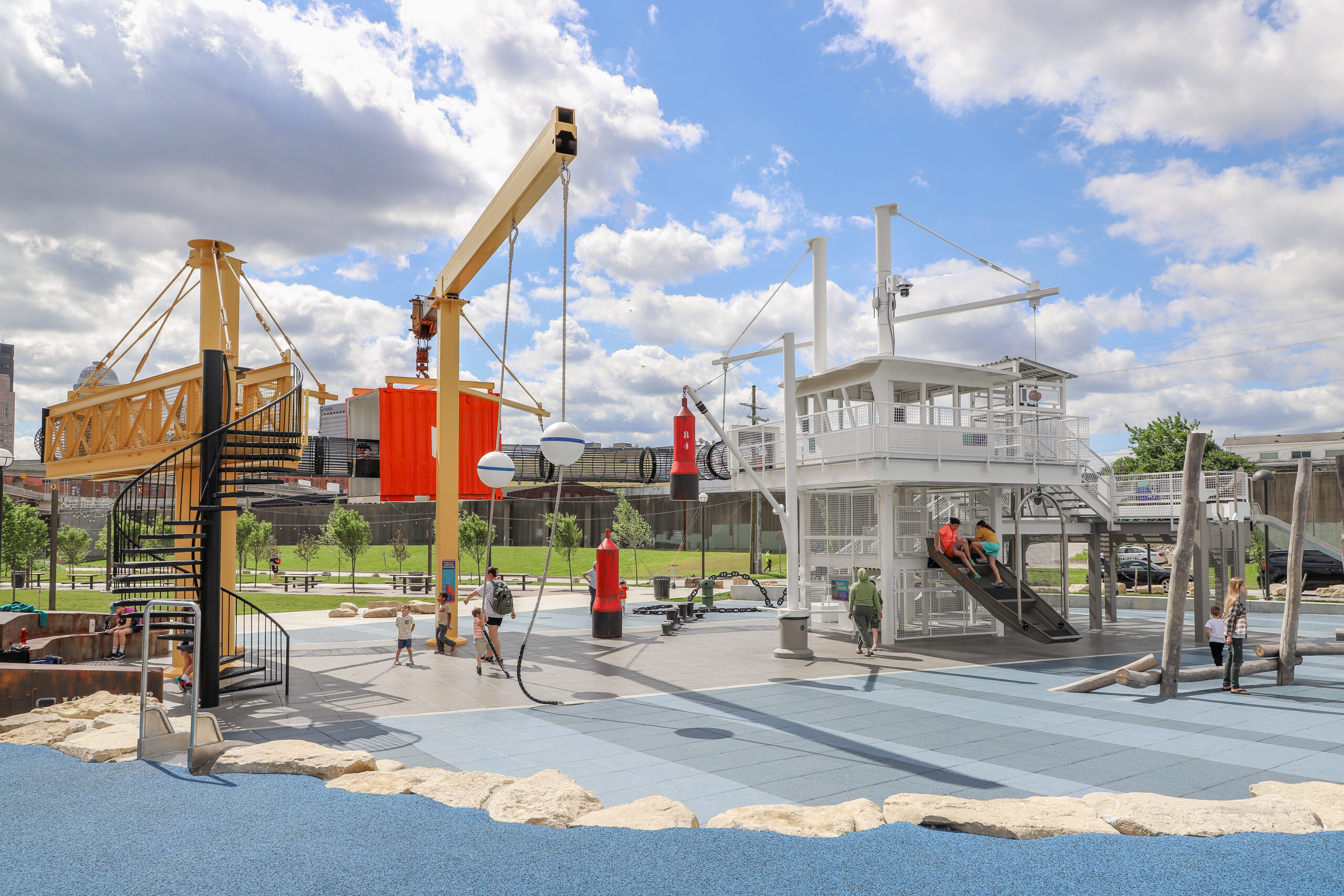 Families using the PlayPort playground at Waterfront Park