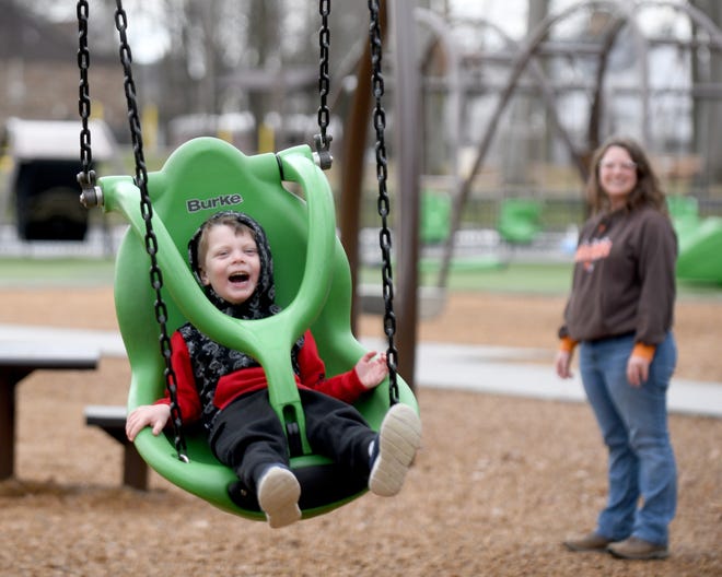 Child using equipment at Possibility Playground in North Canton