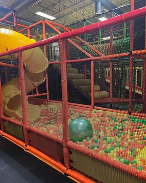 Indoor playground structure with slides and ball pit