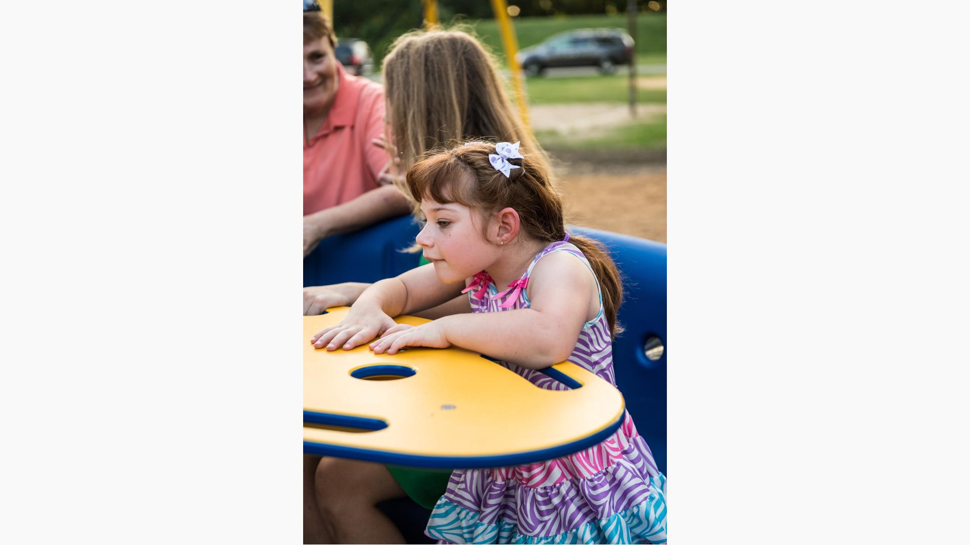 Children playing on the inclusive structure at Riverside Park in Iola