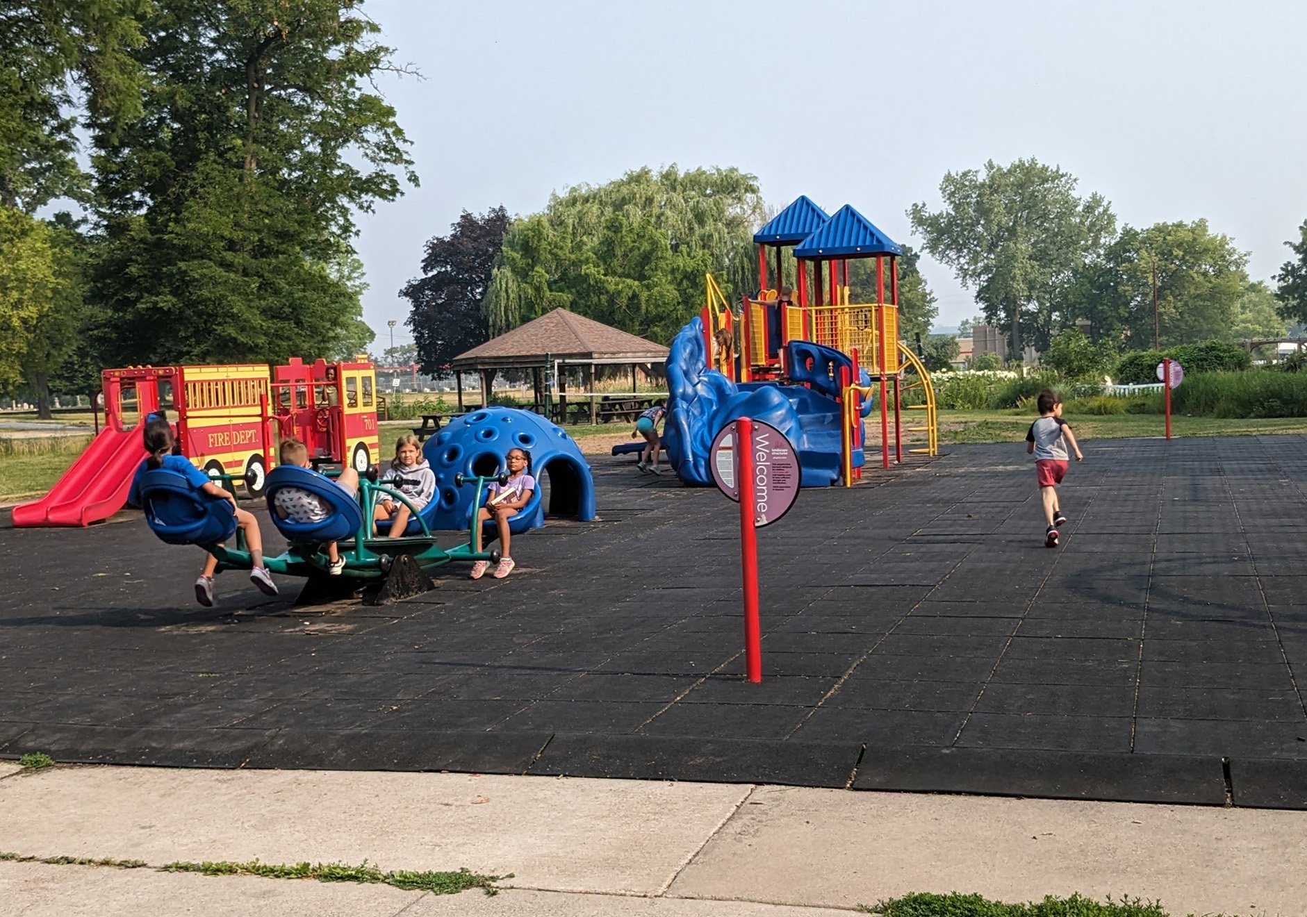 Children using inclusive play features at Riverside Park
