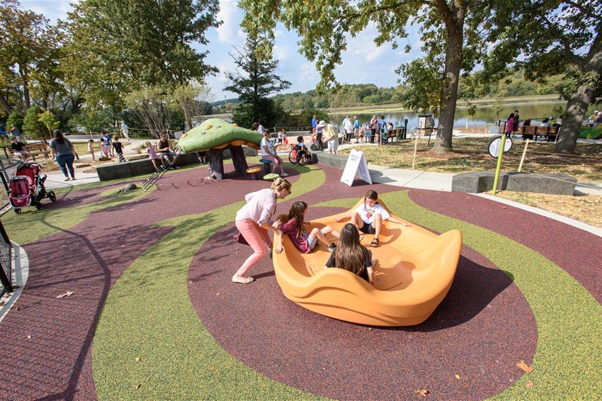 Children using accessible play features at the universal access playground