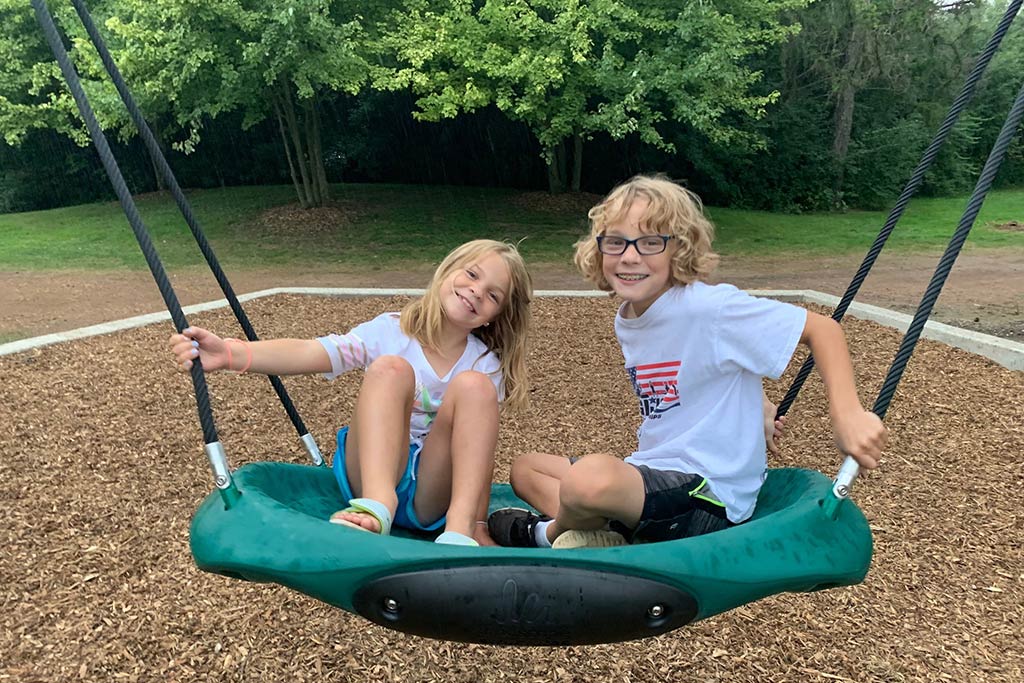 Children using the tree top swings at Sensory Garden Playground