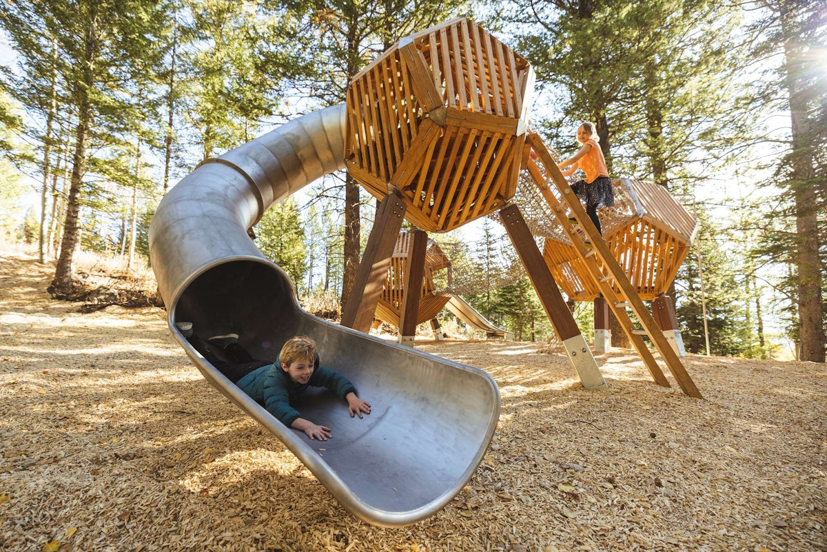 Boy going down a slide at Wild Woods Playground