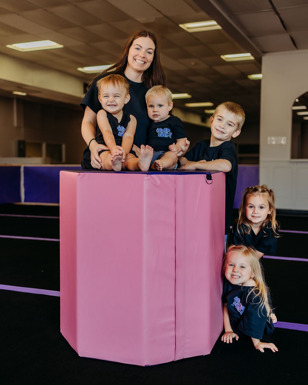Children and a caregiver in the 4Ever Kids gym.