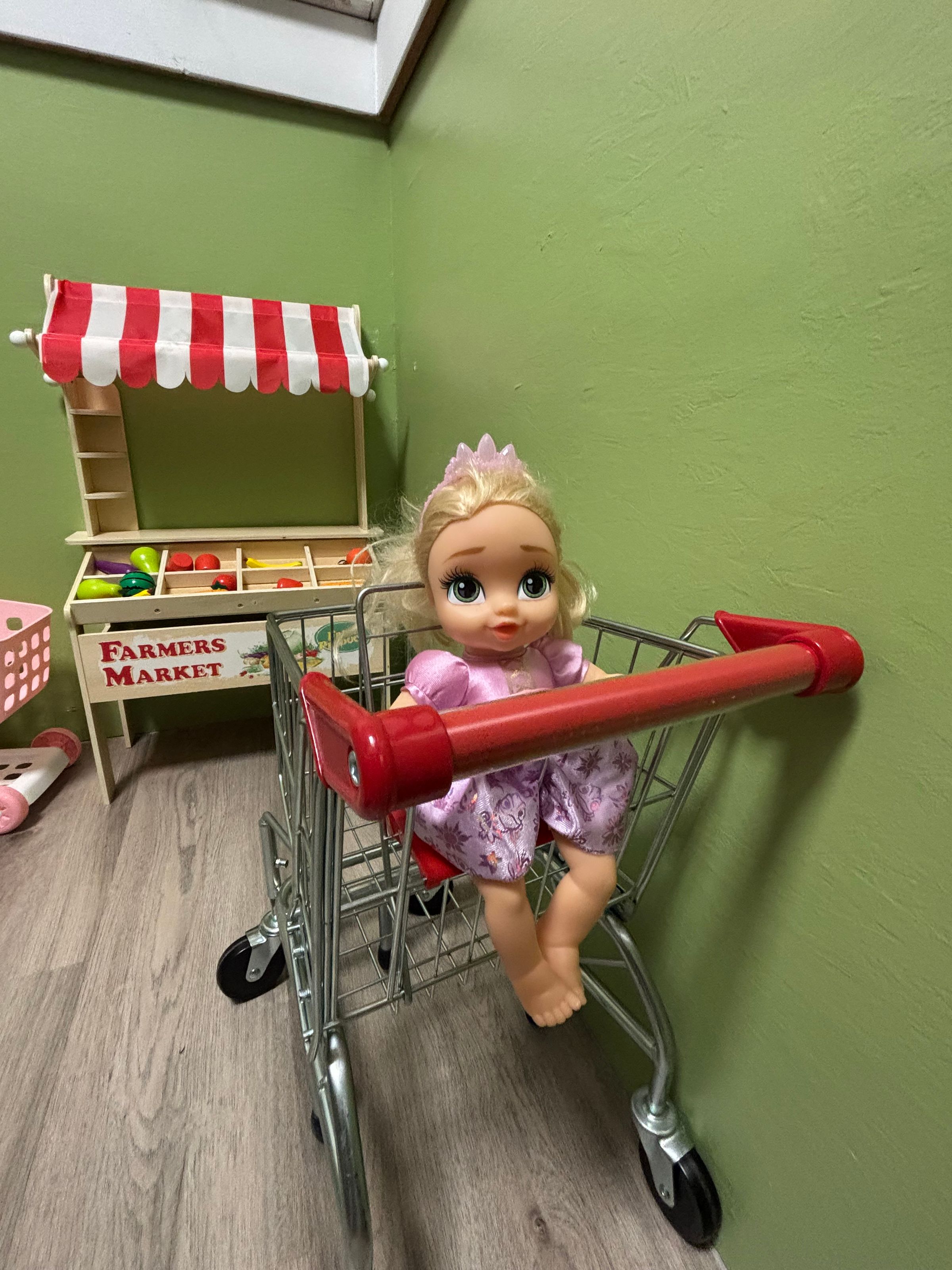 Toy grocery stand and cart inside Adventure Alley