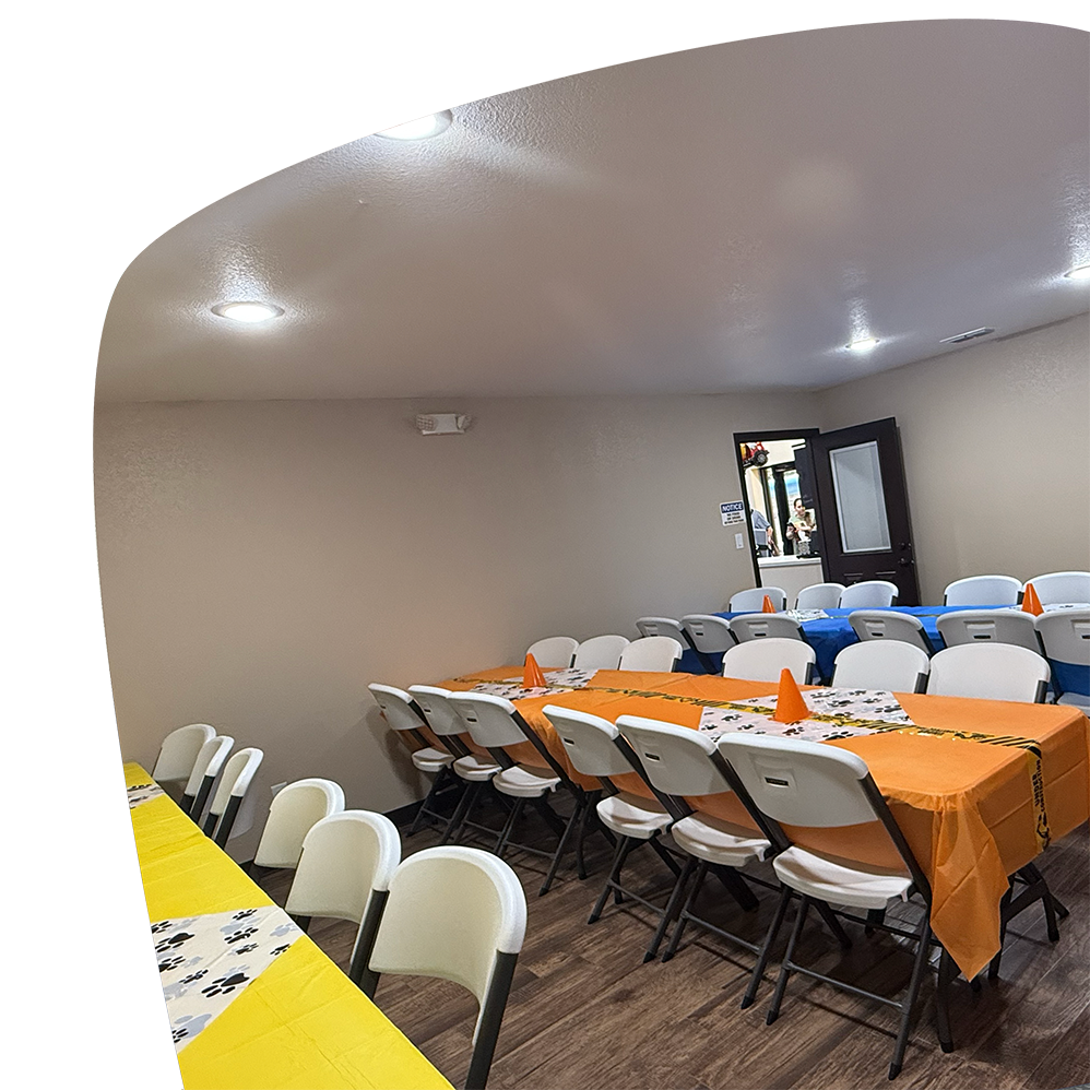 Party room with tables and chairs at Adventure Zone Mineola.
