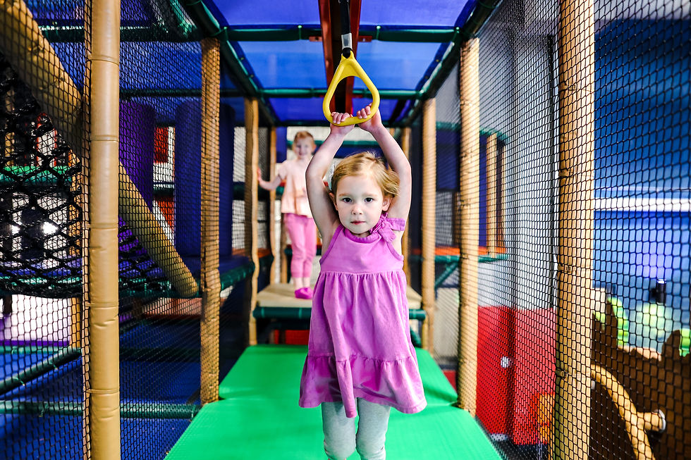 Child using overhead play elements inside Adventureland