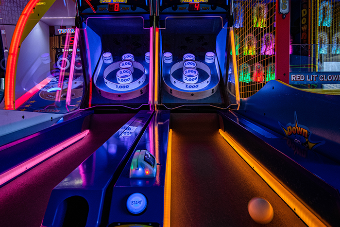 Arcade floor with brightly lit games at All American Fun Park