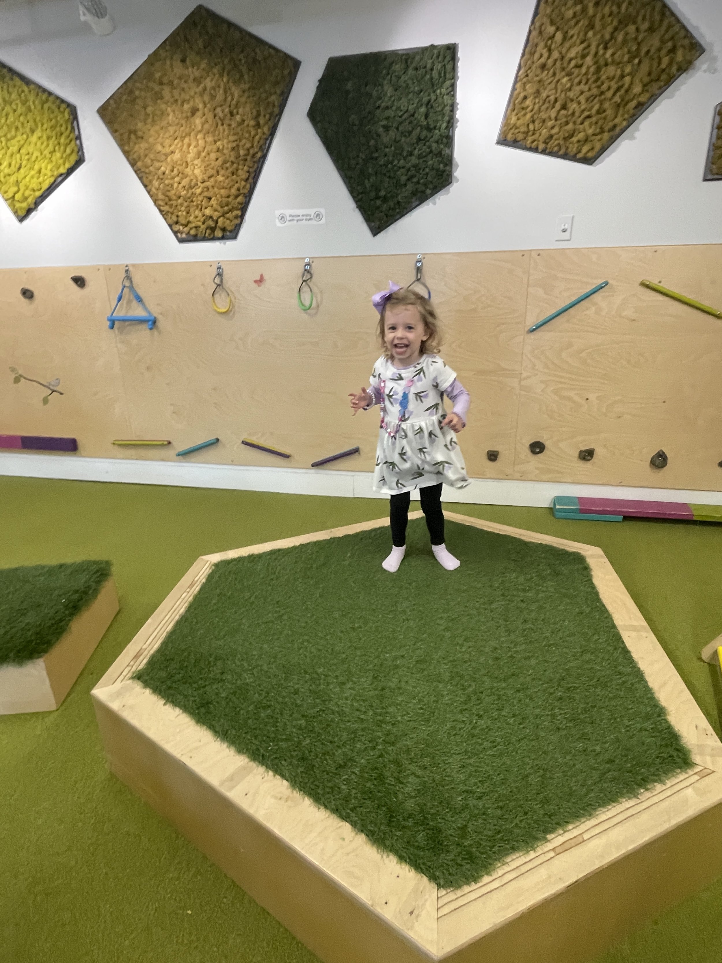 Open play floor and toddler-friendly equipment at Allo Boston.