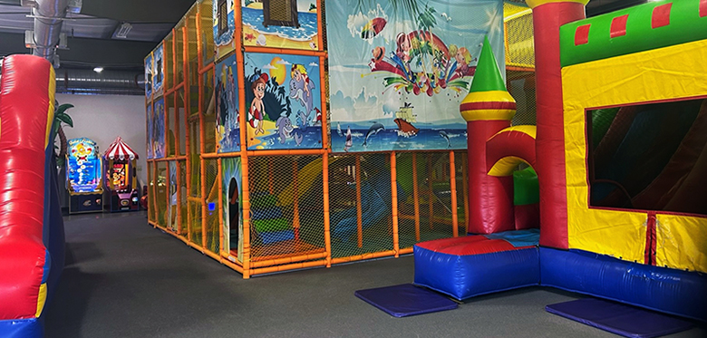 Indoor climbing structure and inflatable play at BB Kidz Klub.