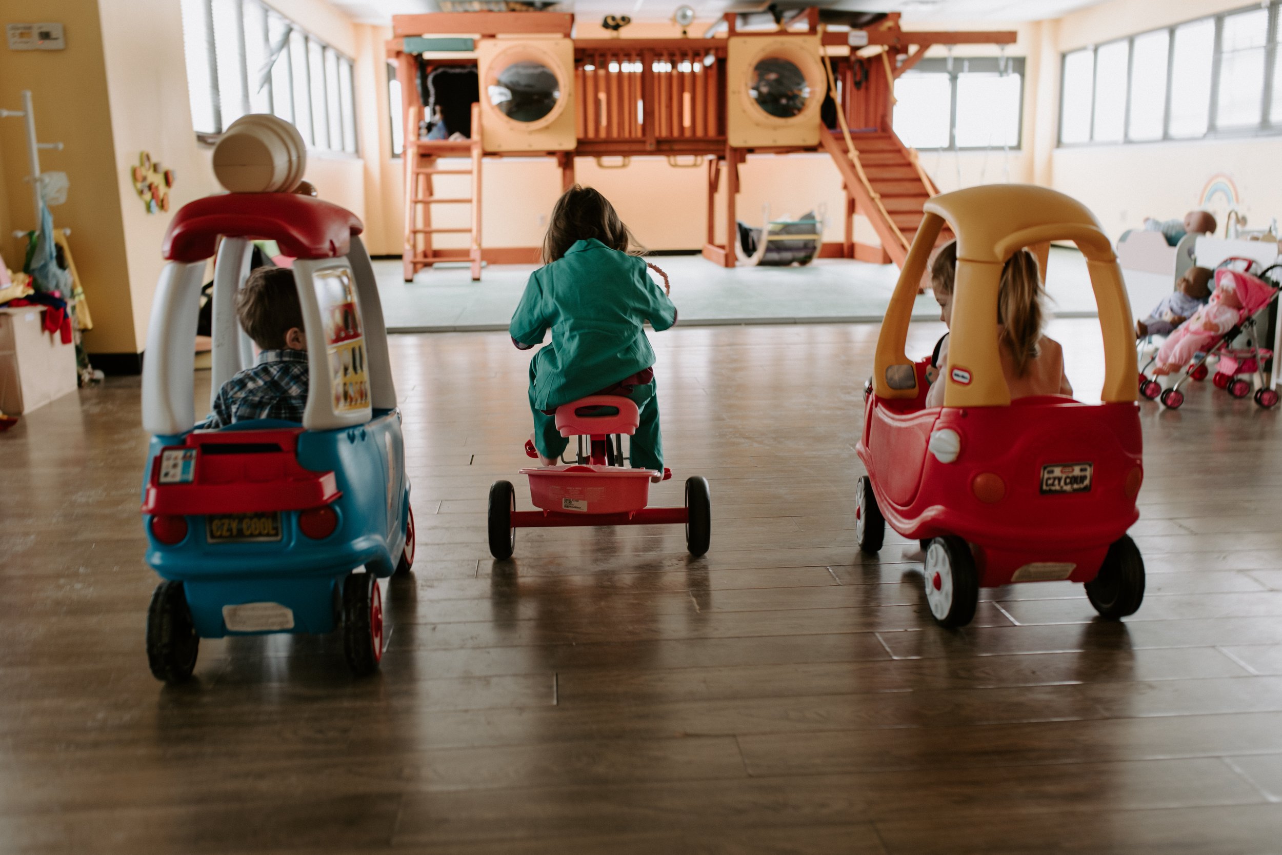 Ride-on toy area facing the main play structure at Beanstalk HQ