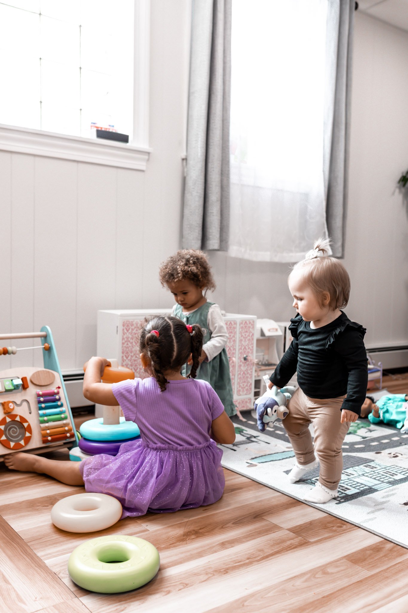 Children playing with toys in a bright room at Bear’s Play Space