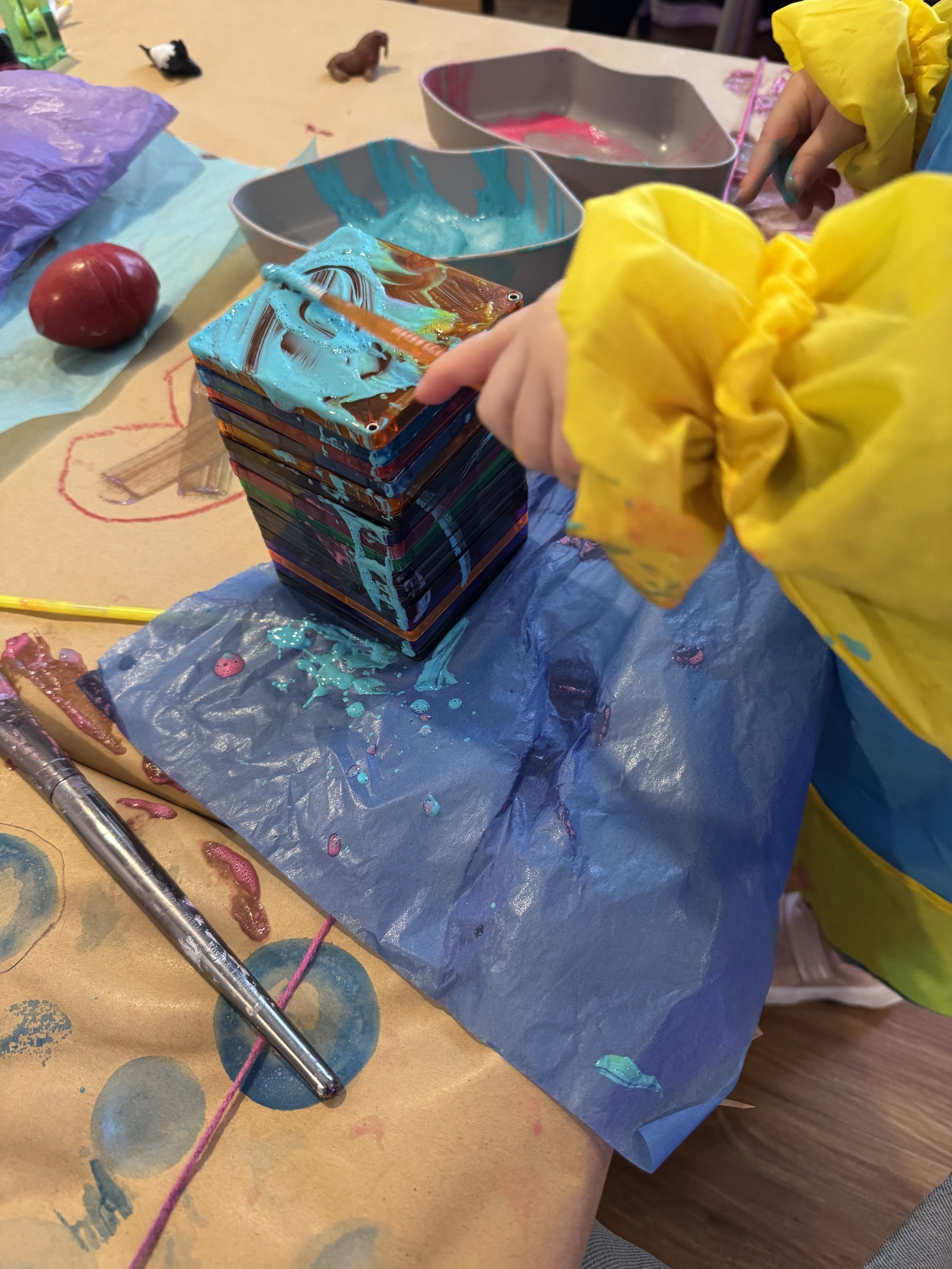Child exploring process art materials at Blossom Play Space.