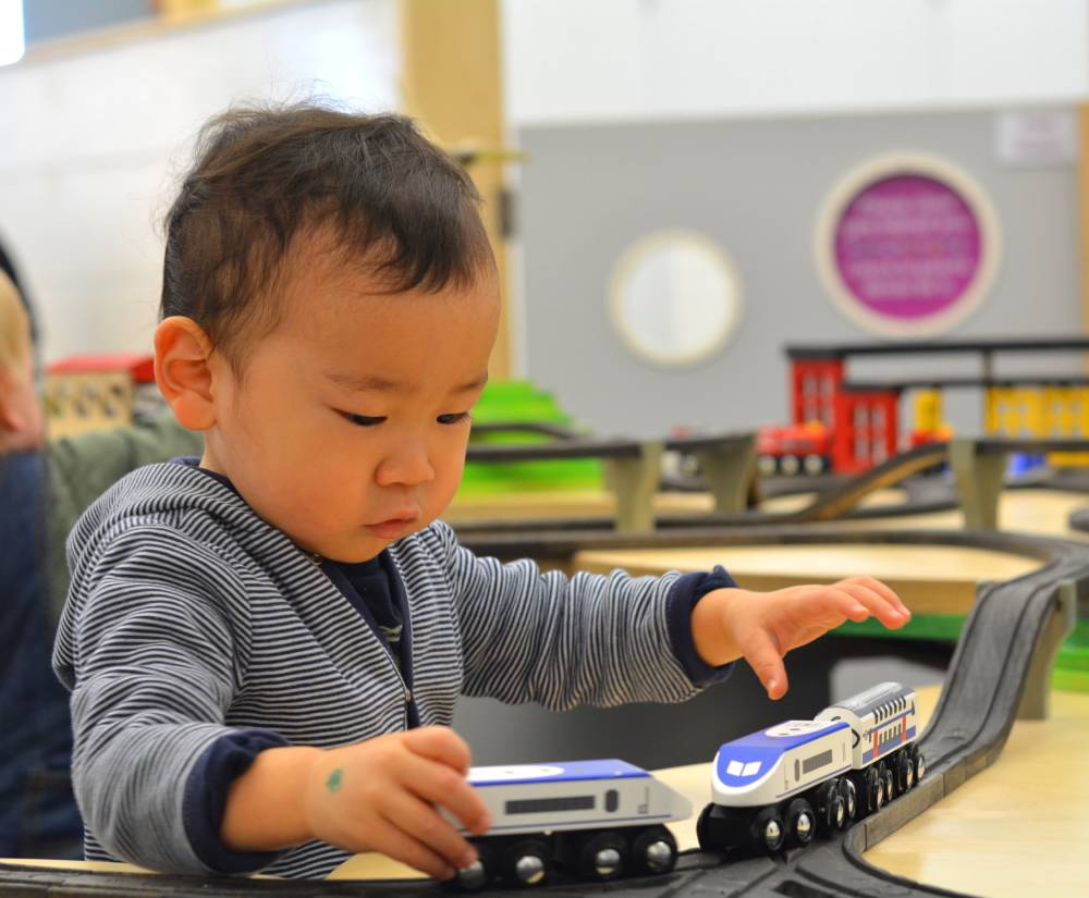 Young children exploring PlaySpace exhibits at Boston Children's Museum.